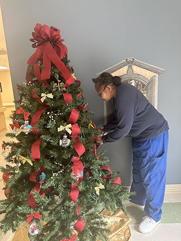 Family helping to decorate for Christmas 2024